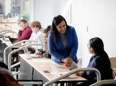 professor assists a student in class
