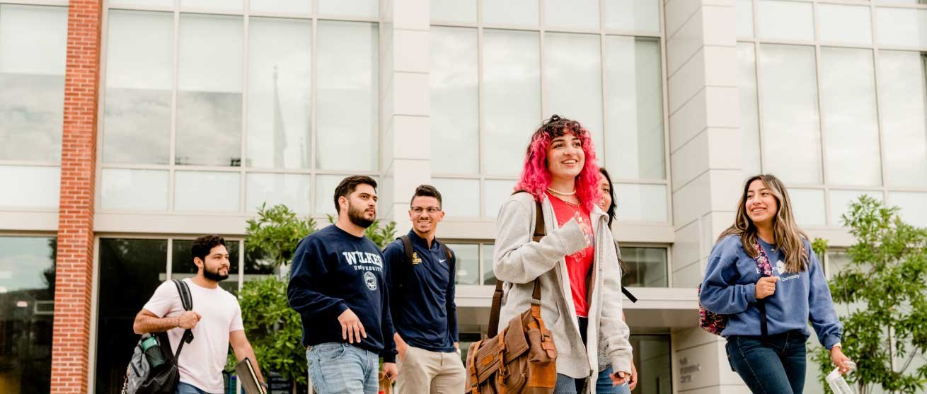 students with backpacks walking and talking